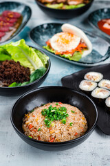 Rice with chicken, soup with noodle and minced pork and flatbread with bacon and fried egg on a table.