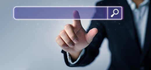 Man standing with hands pointing to information search is a data clicking to virtual internet search page computer touch screen. Education, Knowledge, Analysis the Internet to connect wirelessly.