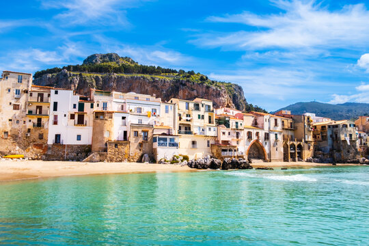 Cefalu, medieval town on Sicily island, Italy. Seashore village with beach and clear turquoise water of Tyrrhenian sea, surrounded with mountains. Popular tourist attraction in Province of Palermo