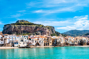 Cefalu, medieval town on Sicily island, Italy. Seashore village with beach and clear turquoise...