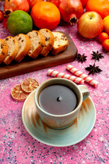 front view delicious fruit composition with sliced cakes and tea on pink desk fresh mellow color ripe exotic vitamine cake biscuit