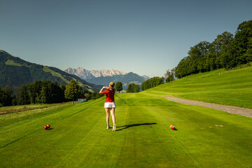 person on a golf course in the mountains 