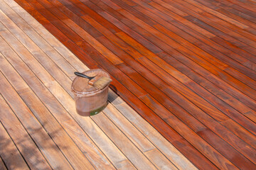 Wood deck paint brush on the bucket