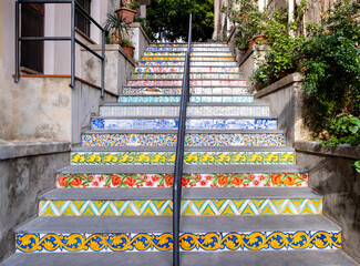 Staircase decorated with ceramic tiles and colorful traditional sicilian ornaments in Cefalu old town, medieval village on Sicily island, Italy. Popular tourist attraction in Province of Palermo