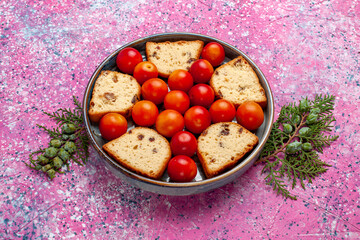 front view delicious sliced cake with sour fresh plums inside pan on pink background pie sweet sugar bake biscuit cookie fruit
