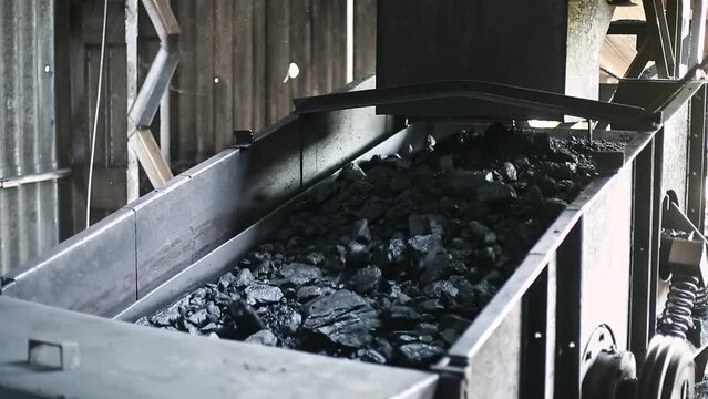 Closeup of charcoal or bituminous coal moving downward into the furnace chamber