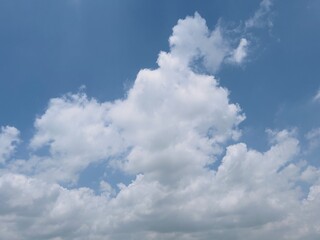 Fototapeta na wymiar Blue sky with clouds in summer sunlight