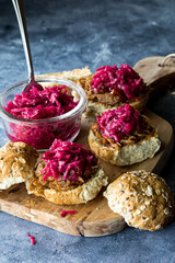 Toasted pulled pork slider buns topped with pickled beet and cabbage sauerkraut.