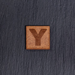 Capital Letter In Square Wooden Tiles - Black Stone Background