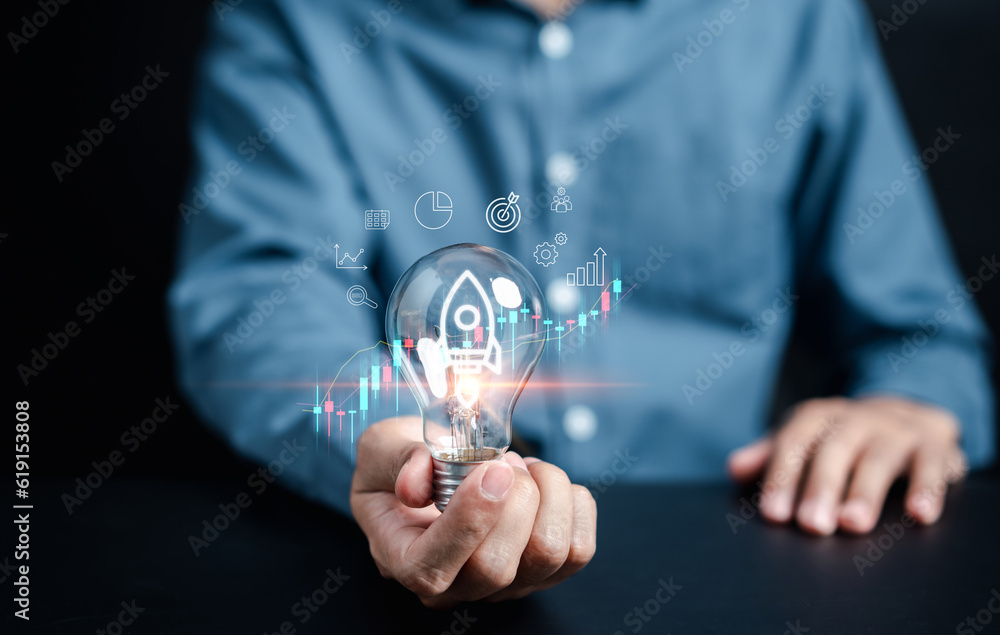 Aufkleber hand business holding light bulb with rocket launch icon, fast start up business to goal and success