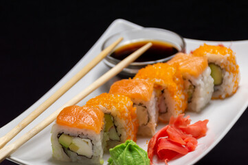 Rolls with salmon, wasabi, red ginger and soy sauce