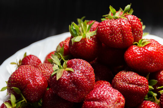 Ripe, Juicy Strawberries On A White Plate