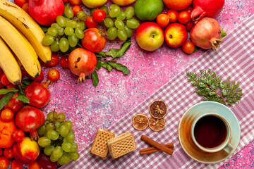 top view fresh fruit composition colorful fruits with cup of tea and waffle on pink background fruit fresh mellow color ripe
