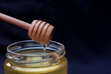 We take natural honey from a jar with a special wooden spoon