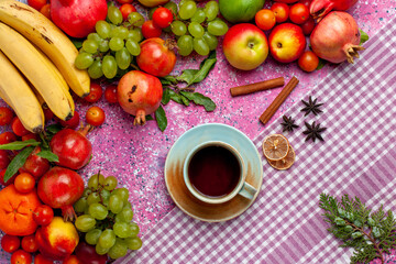 top view fresh fruit composition colorful fruits with cup of tea on light-pink background fruit fresh mellow color ripe