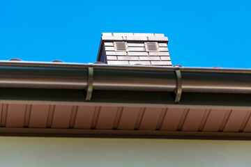 Brick chimney with two ventilation grilles, bottom view