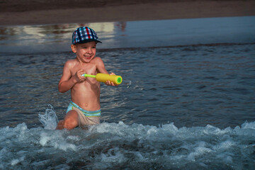 Obraz na płótnie Canvas Little boy having fun in the sea. Happy summer family vacation. Tropical vacation.