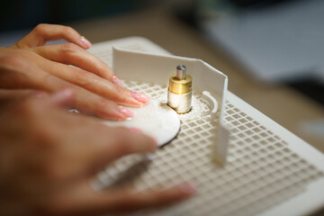 Glass grinding in a home workshop. Production of stained glass. Handicraft. A girl creating. Glass...