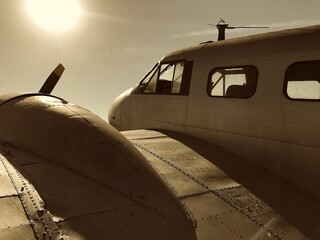 old vintage aircraft on the ground at sunset