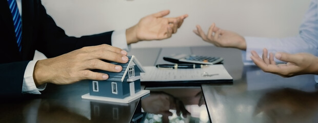 hand. The real estate agent explains the business contract