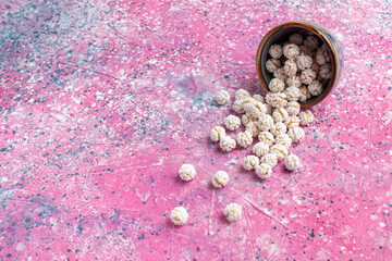 front view white sweet confitures on the pink background candy sugar sweet tea color bonbon