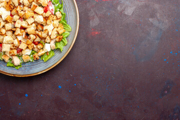 top view caesar salad with sliced vegetables and rusks on dark background vegetables salad food...