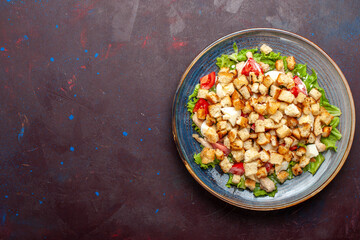 top view caesar salad with sliced vegetables and rusks on the dark background vegetables salad food lunch meal rusk taste