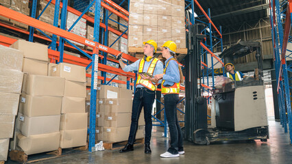 Caucasian man, woman warehouse supervisor discuss and use tablet check package with forklift driver worker load box on shelf, product distribution inventory management,Logistics shipping business plan