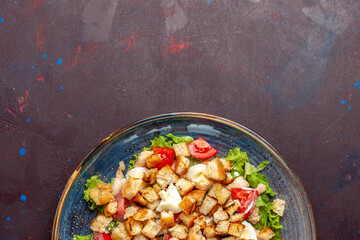 top view caesar salad with sliced vegetables and rusks on the dark desk vegetable salad food lunch meal rusk taste