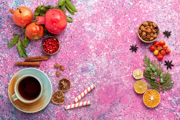 top view fresh pomegranate with green leaves and cup of tea on pink background fruit fresh mellow autumn tree plant
