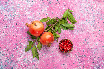 top view fresh pomegranate with green leaves on pink background fruit fresh mellow autumn tree plant color