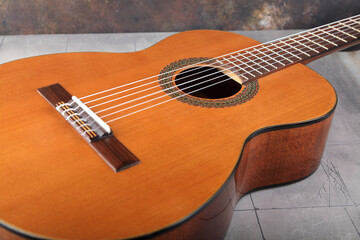 Mahogany classical guitar on vintage background.