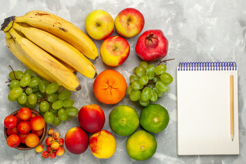top view fresh yellow bananas mellow and delicious fruits with fresh grapes apples on light-white desk fruit fresh mellow tropical