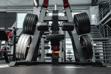 Modern fitness center interior with sports equipment - sport weight barbell on rack. New gym...