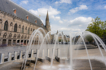 Fountains in the market square of Ypres on a beautiful sunny day. Tourist image for promotion of Ypres Belgium or Ieper België.  Capital of the westhoek belgium.  Lakenhalle, Belfort, Niewerck.