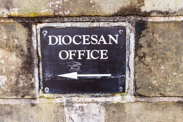 Sign pointing to the Diocesan Office of a church.