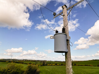 15kVA transformer mounted on a wooden pole in a rural setting.