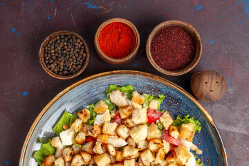 top view tasty caesar salad with seasonings on dark background vegetables salad food lunch meal rusk taste