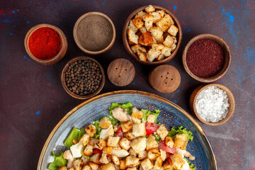 top view tasty caesar salad with sliced vegetables and rusks inside plate on dark background vegetable salad food lunch meal rusk taste