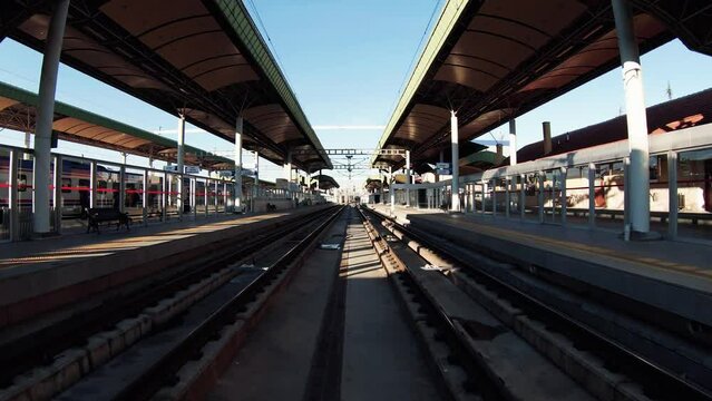 4K drone going advancing and ascending forward over railway tracks, platforms and train station stock video. 