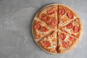 Pepperoni pizza with sausage gray concrete background.