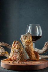 front view dried sliced fish with glass of wine on a dark background seafood vobla sea ocean water color meat fish