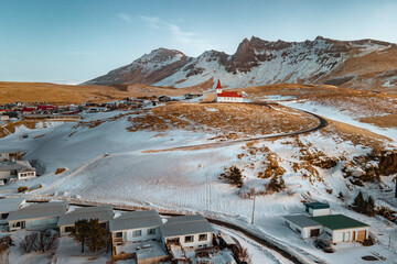 Aerial view - The village red church of Vik, Reyniskirkja Church at southern Iceland