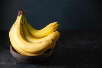 front view fresh yellow bananas on dark background exotic fruit food darkness tropical taste photo