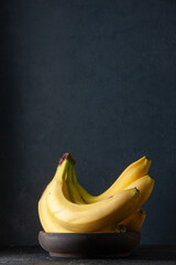 front view fresh yellow bananas on dark background exotic fruit ripe food darkness taste photo tropical