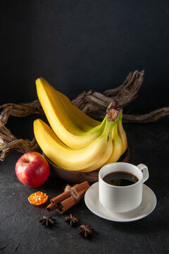 front view fresh yellow bananas with cup of coffee on dark background exotic ripe darkness taste photo tropical fruit berry