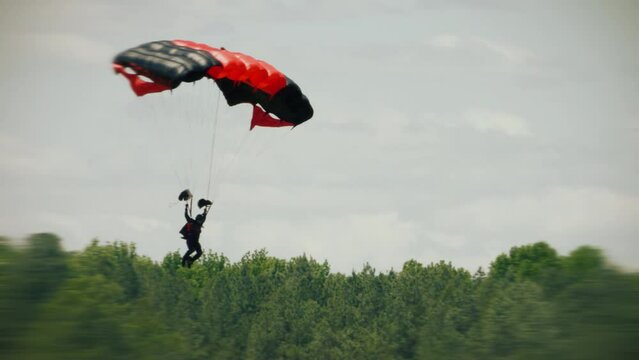 Skydiving. Parachute jump. Extreme sport. Paratrooper.