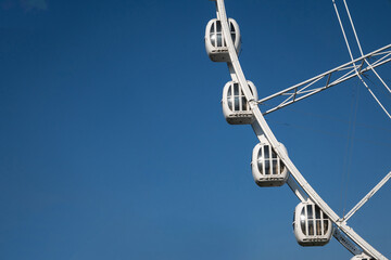 Fototapeta premium ferris wheel ride in amusement park on blue sky background. High quality photo