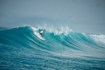 Surfer on perfect blue aquamarine wave, empty line up, perfect for surfing, clean water, Indian Ocean