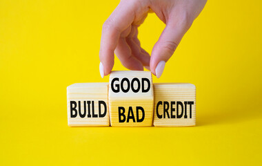 Build Good or Bad Credit symbol. Businessman hand turns wooden cubes and changes the words Build...